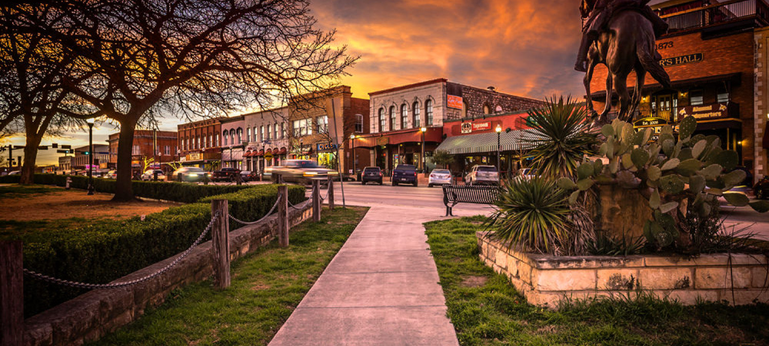 San Marcos downtown businesses with sunset in background